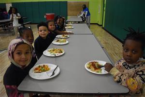 students  sitting at a table with their nachos